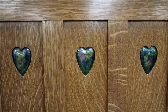 Shapland & Petter of Barnstaple. An Arts & Crafts oak triple wardrobe, W.6ft 9.5in.
